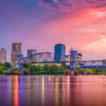 Little Rock, Arkansas, USA skyline on the Arkansas River at dusk.