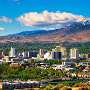 Downtown Reno skyline, Nevada, with hotels, casinos and the surrounding High Eastern Sierra foothills